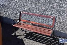 A 20th century garden bench having cast ends and back support