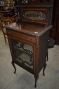 A 19th Century mahogany and inlaid music or display cabinet having mirror back, width approx. 57cm