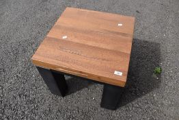 A modern occasional/coffee table having natural wood top
