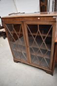 An early 20th Century bleached mahogany bookcase on bracket feet