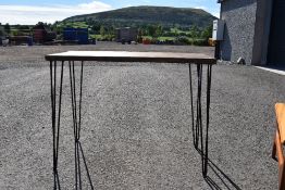 A stained frame side table on hairpin legs, width approx 100cm