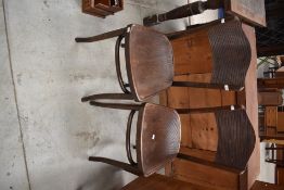 A pair of early 20th Century bentwood chairs having grooved ply seats and backs