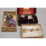 A selection of badges including Womens Voluntary service, a gold tone bar brooch with swallow