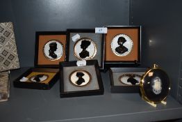 Six hand painted silhouettes under glass, framed and mounted, also included is a similar cameo.