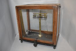 A set of Griffin and Tatlock Microid balance scales in glass and wood case.
