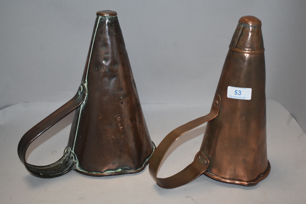 Two antique copper ale mullers.
