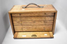 An oak cabinet makers chest of small proportions, having four drawers, leather carrying handle and