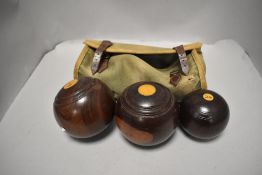 A set of lignum vitae crown green bowls with canvas case