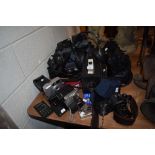 A mixed lot of camera equipment, including Canon, Polaroid, Panasonic camcorder and much more.