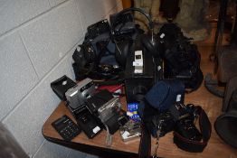 A mixed lot of camera equipment, including Canon, Polaroid, Panasonic camcorder and much more.