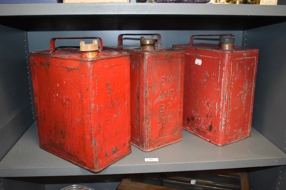 Three vintage fuel cans including BP and Pratts.