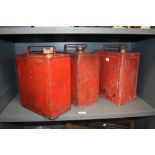 Three vintage fuel cans including BP and Pratts.
