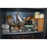 A shelf full of vintage and antique kitchenalia, including enamel storage tins, stoneware flagon,