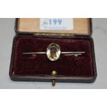 A white metal bar brooch stamped silver having a large central oval citrine of pale colour