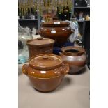 Four vintage earthen ware storage jars and tureens.