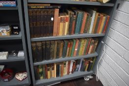 Three shelves of library volumes including history and military with a set of Winston Churchill