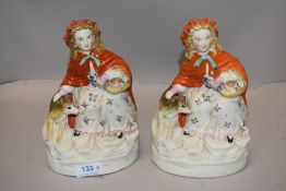 A pair of Victorian Parian ware figures of Red Riding Hood having painted details