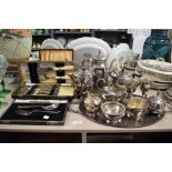 An assortment of plated ware to include boxed fish serving set, tea pots, jugs, tray and more.