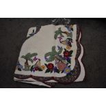 A 20th century American style bed quilt with hand sewn floral details and decals