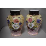 A pair of late Victorian glass vase having mirrored decoration of flowers on pink ground