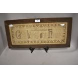 An early 20th century religious needlepoint in carved oak frame.