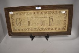 An early 20th century religious needlepoint in carved oak frame.