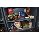 An array of vintage advertising tins and collectables, including National dried milk powder, Cerebos