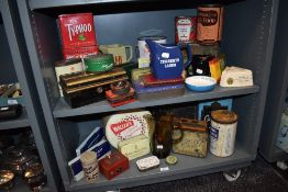 An array of vintage advertising tins and collectables, including National dried milk powder, Cerebos