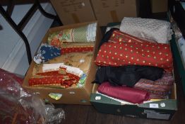 Two boxes full of good quality fabric, predominantly upholstery.