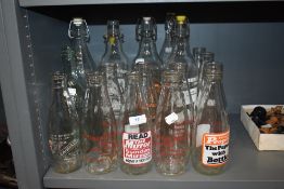 A good quantity of vintage advertising milk bottles and soda bottles, amongst which are local area