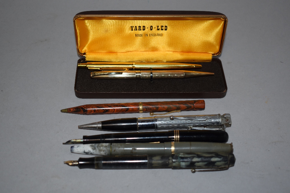 A Lever fill Swan fountain pen having black barrel with gold band trio to cap, a Ronson