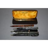 A Lever fill Swan fountain pen having black barrel with gold band trio to cap, a Ronson