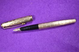 A gold tone Parker 61 Stratus convertible cartridge pen having textured barrel.