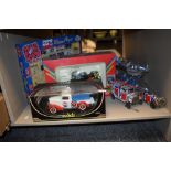 A collection of retro Pepsi themed toys including planes, bike and car.