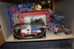 A collection of retro Pepsi themed toys including planes, bike and car.