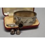 A vintage white metal etched bangle and a bar brooch having bell details, marked silver to rear.