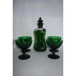 A mid century green glass Kluk-Kluk decanter and four glasses.