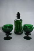 A mid century green glass Kluk-Kluk decanter and four glasses.