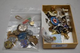 A selection of 20th century Girl Guides pin badges with a selection cuff links and similar