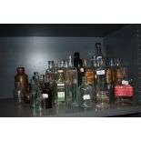 An assortment of vintage and antique bottles including chemist and food and drink interest.