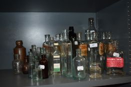 An assortment of vintage and antique bottles including chemist and food and drink interest.