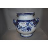 A large bulbous 19th century planter, having handles to sides, blue and white transfer pattern and