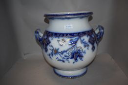 A large bulbous 19th century planter, having handles to sides, blue and white transfer pattern and