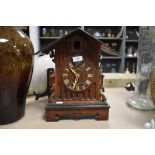 An early 20th century oak case cuckoo clock