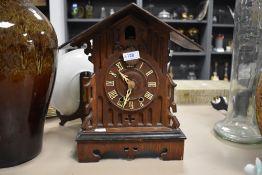 An early 20th century oak case cuckoo clock