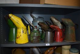 A selection of vintage oil cans and jugs or varying sizes.