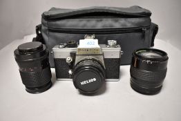 A Praktica LTL camera with Helios 28mm lens No85857-5, a Makinon 135mm lens No 912481, and a Carl
