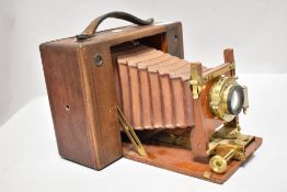 A Cartridge Kodak No4 4x5 format camera in wooden case with red bellows