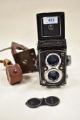 A Yashica-Mat reflex camera with Yashicon 80mm lens in leather cover
