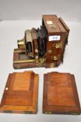 A mahogany cases field camera with brass lends and two plate holders A/F